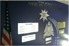 The Wall of Recognition inside Tucson Youth Development's lobby honoring Angel Charity for Children and affiliates